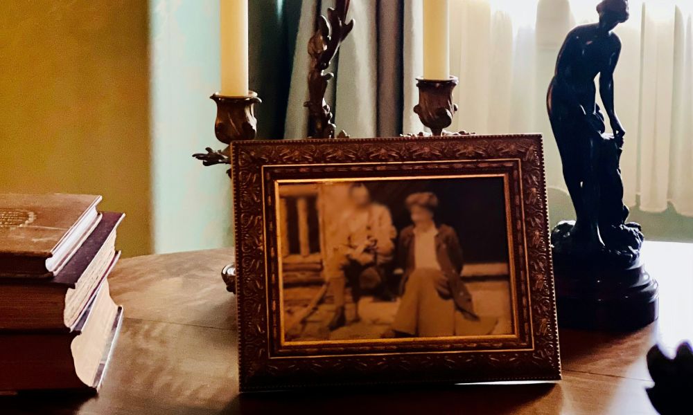 antique picture on a table with candles and other decor