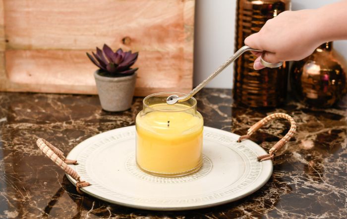 Trimming a wick of a yellow candle