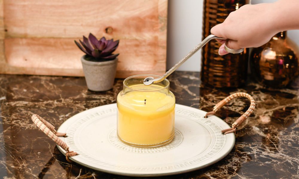 Trimming a wick of a yellow candle