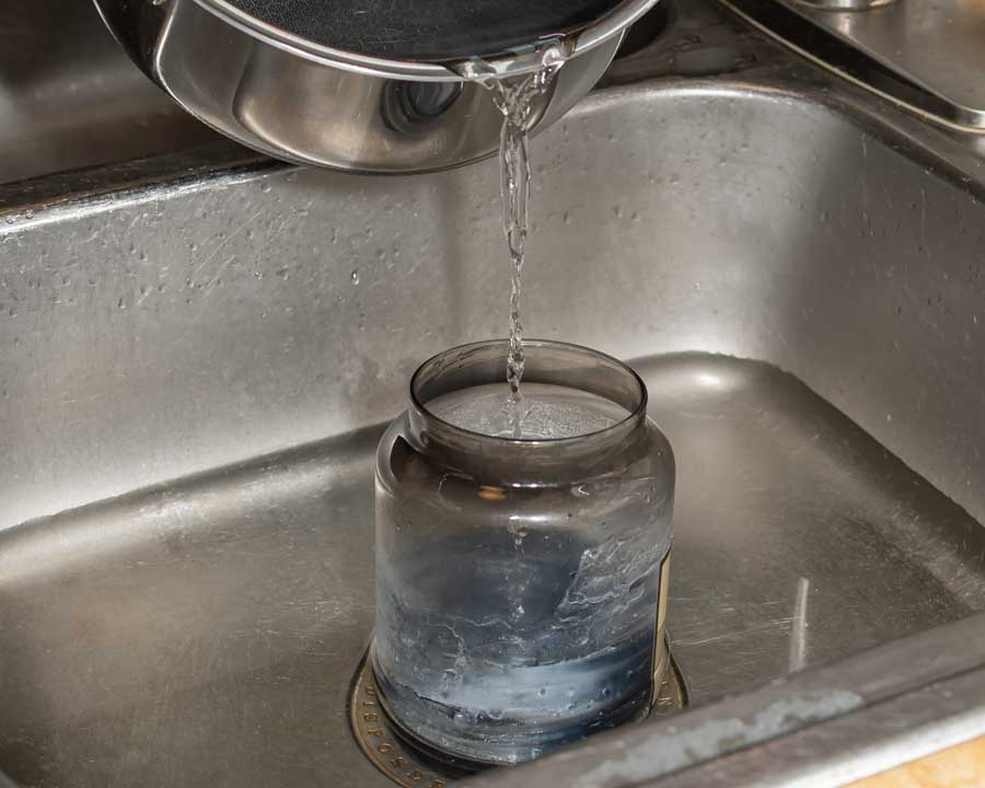 Boiling Water Pouring in a Dirty Jar