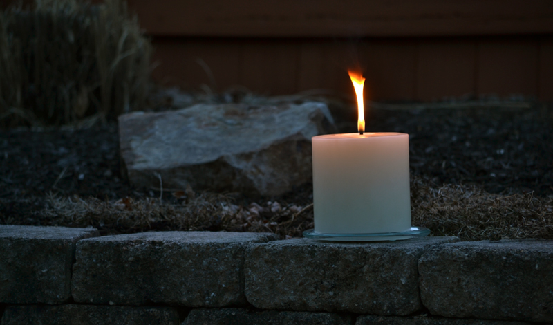 lit outdoor pillar candle