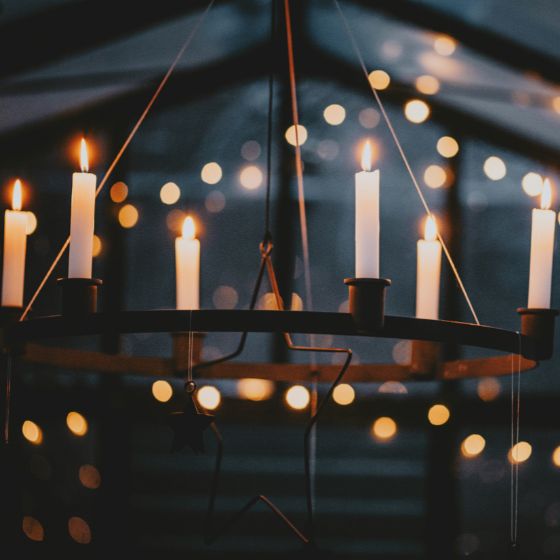 tapers in a metal chandelier