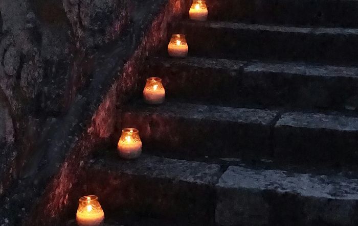 votives in cups lining the edge of a staircase