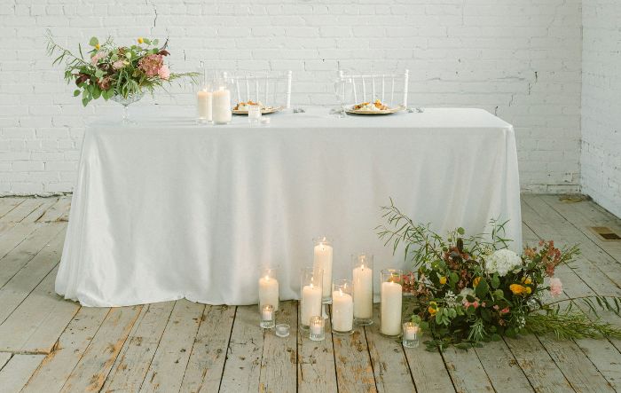 candlelit sweetheart table with floral decor
