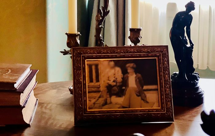 antique picture on a table with candles and other decor