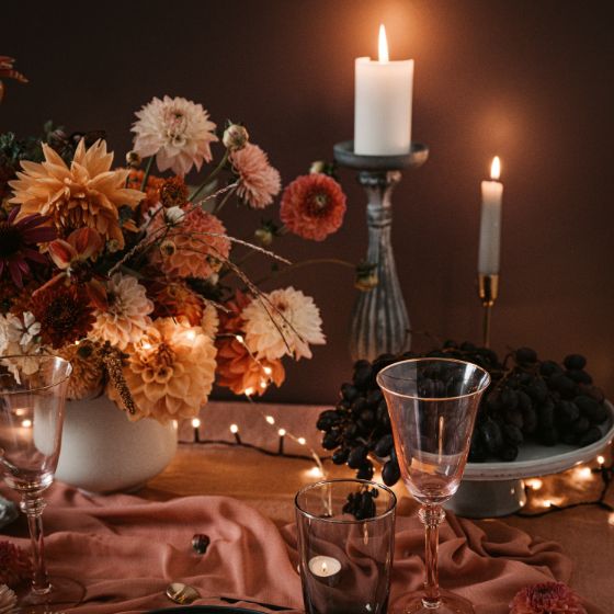 wedding table decor with 3 types of candles: a pillar, taper, and tealight