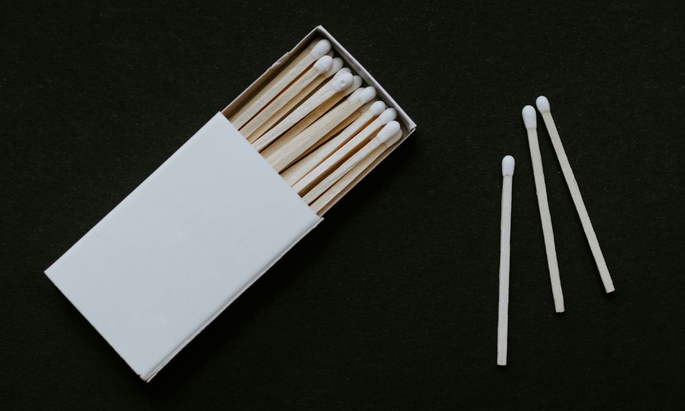 white matchbox with 3 matches out of the box