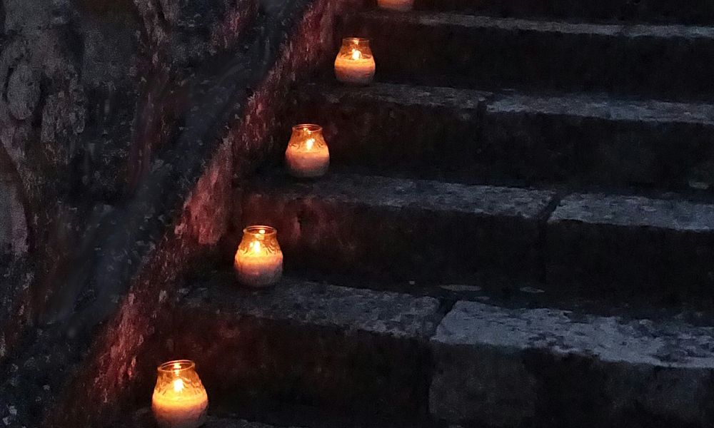 votives in cups lining the edge of a staircase