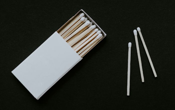 white matchbox with 3 matches out of the box